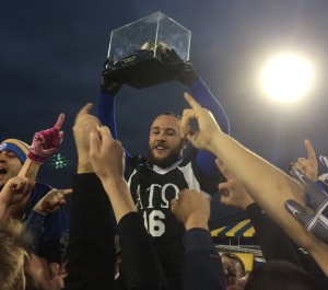 A brother of Alpha Tau Omega holding the trophy after their win on Nov. 8 at Dix Stadium.